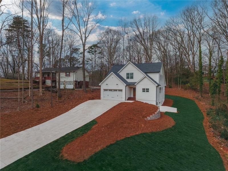 Front exterior of a new home in , Woodstock, GA, highlighting curb appeal (Image 18).