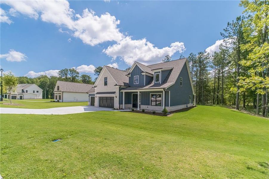 Front exterior of a new home in , Loganville, GA, highlighting curb appeal (Image 26).