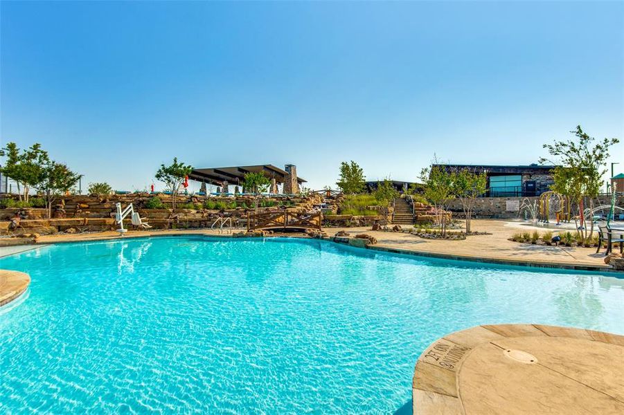 View of community swimming pool featuring a patio area