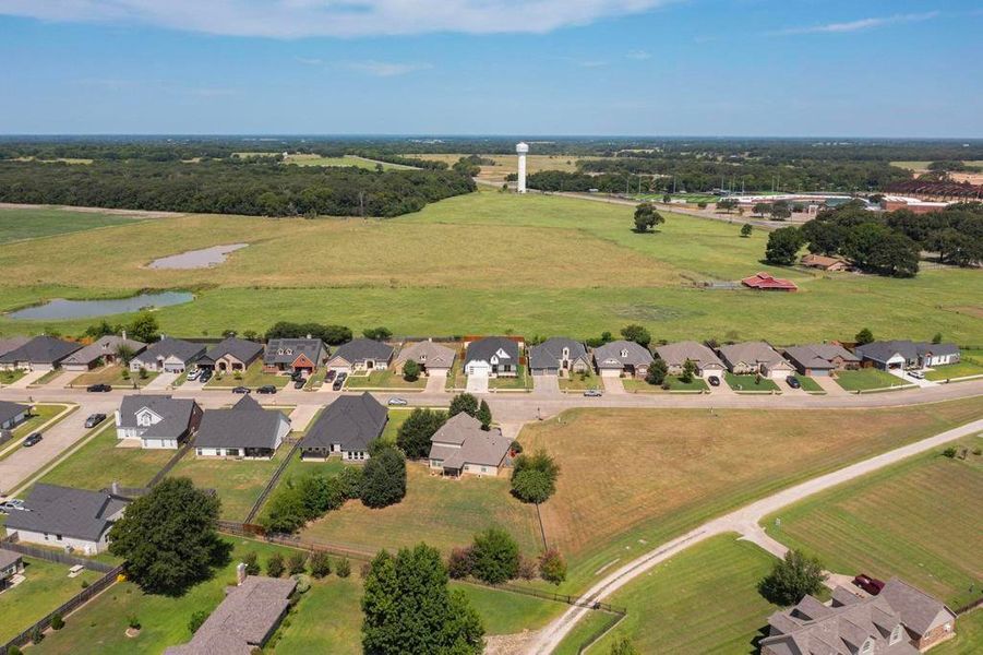 Aerial overview of property's location with a nearby body of water and nearby suburban area