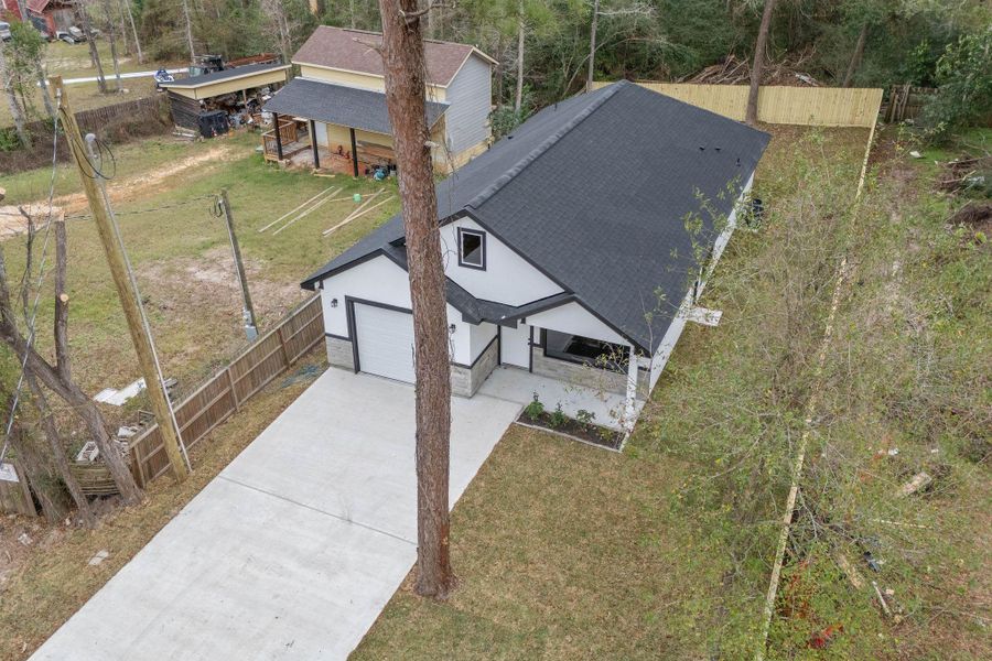 Front exterior of a new home in , Willis, TX, highlighting curb appeal (Image 24).