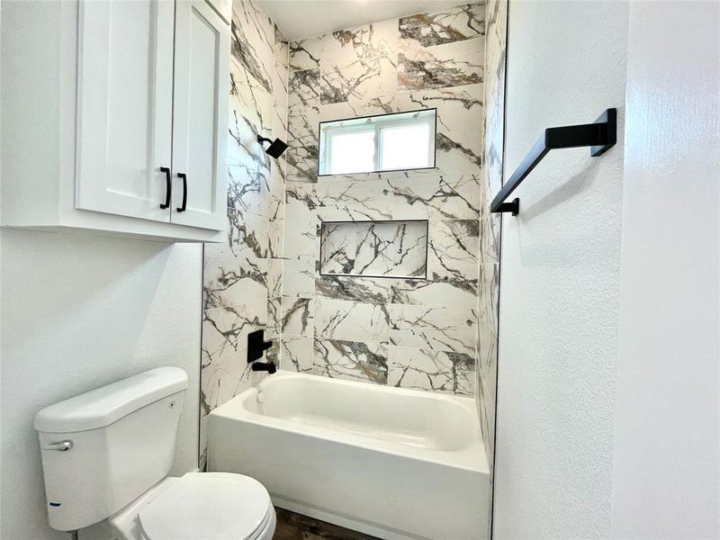 Full bath with bathtub / shower combination and toilet Full bath with bathtub / shower combination and toilet