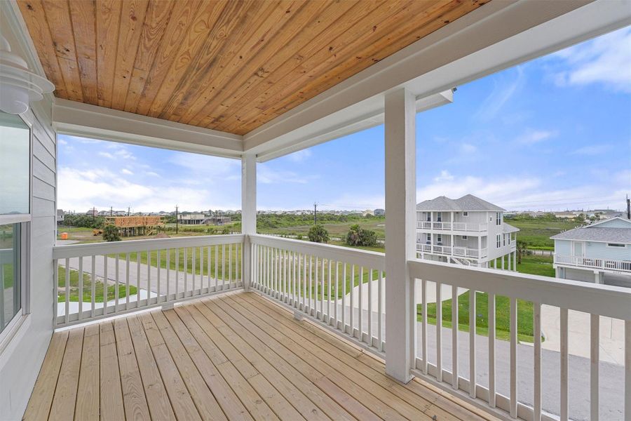 Relax on the second-story balcony and take in open views of the neighborhood and natural landscape beyond. Relax on the second-story balcony and take in open views of the neighborhood and natural landscape beyond.
