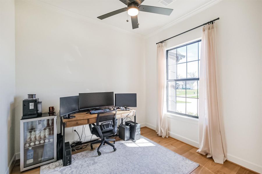 Flexible home office or study with hardwood flooring.