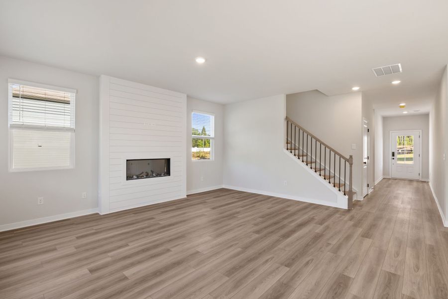 A room with a wood floor and white walls.