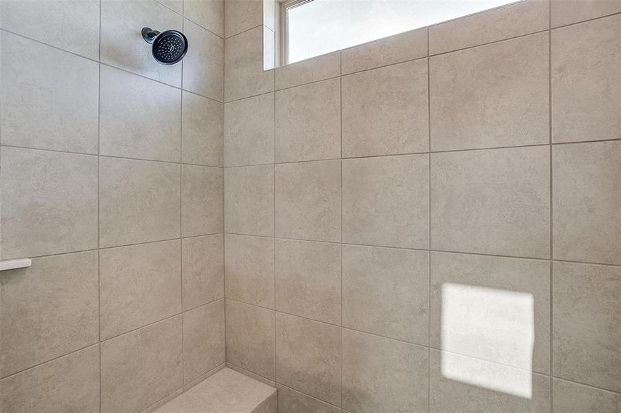 Bathroom featuring a tile shower