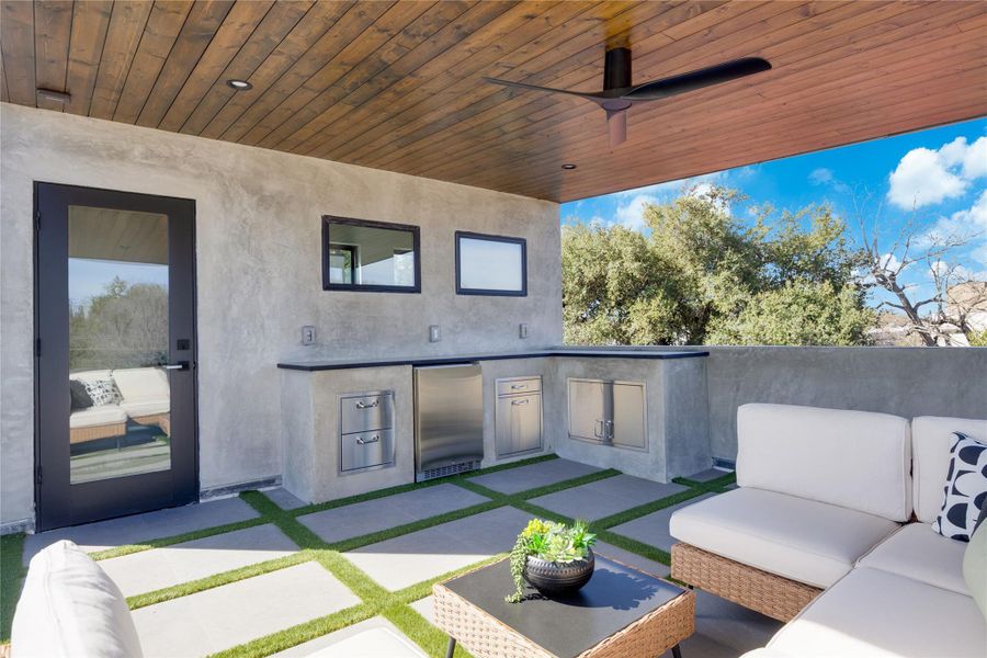 View of rooftop patio with an outdoor kitchen and area to lounge. Sunset and sunrise are amazing from this location.