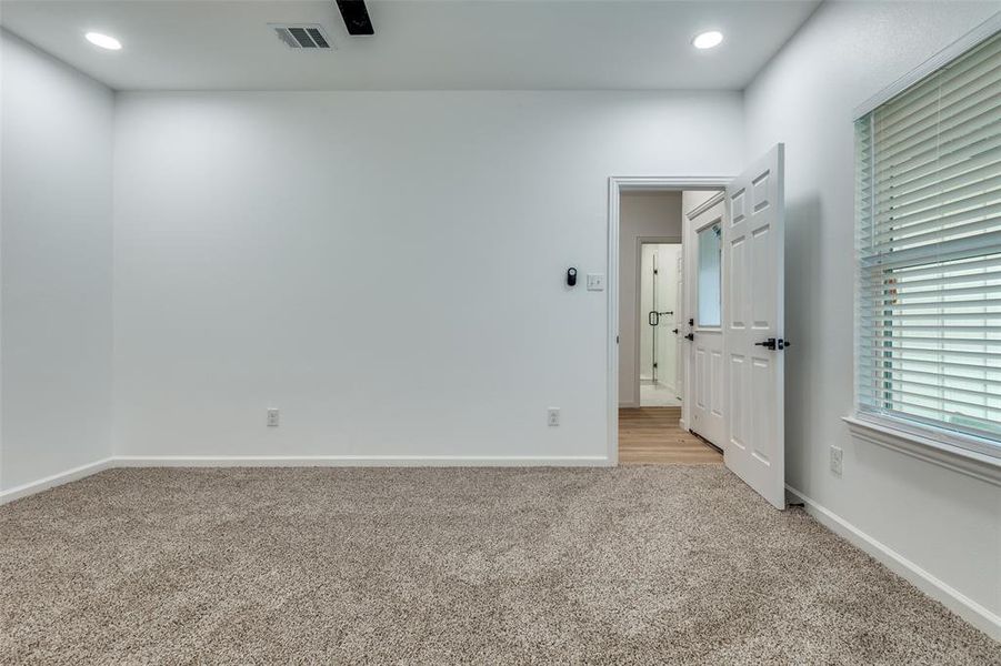 Unfurnished bedroom with light colored carpet, recessed lighting, and a ceiling fan Unfurnished bedroom with light colored carpet, recessed lighting, and a ceiling fan