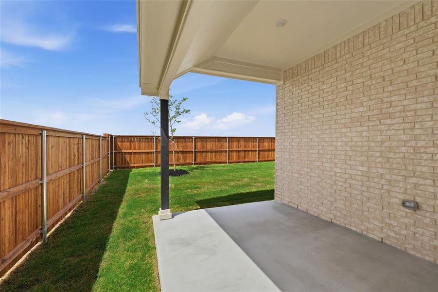 Fenced backyard with a patio area