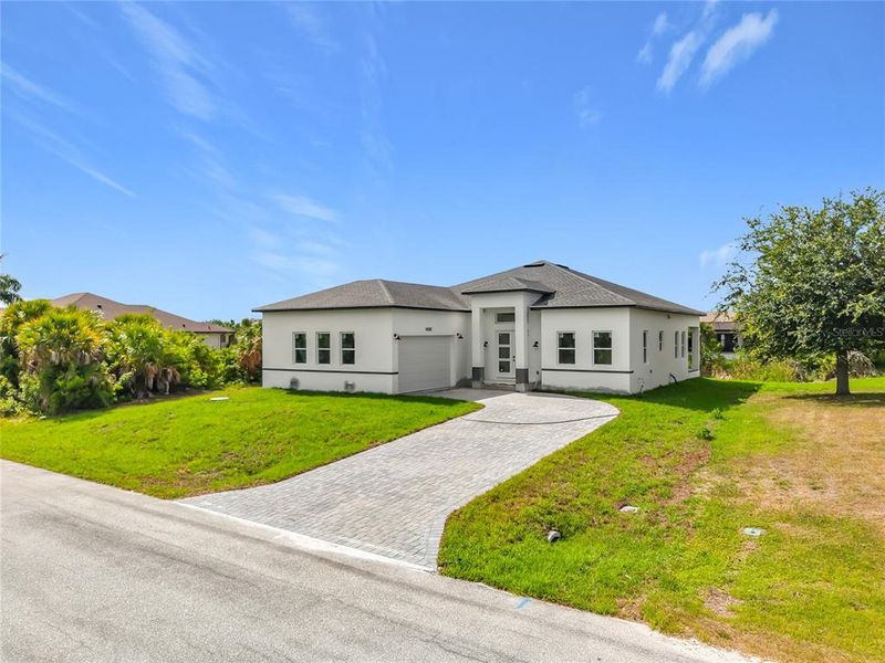 Front exterior of a new home in , Port Charlotte, FL, highlighting curb appeal (Image 18).