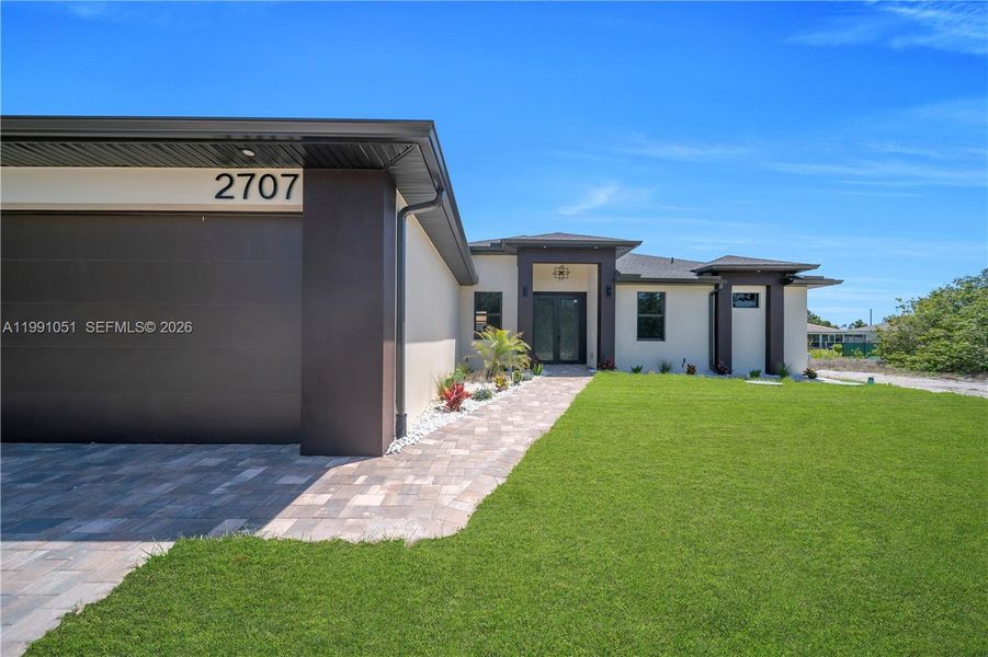 Front exterior of a new home in , Lehigh Acres, FL, highlighting curb appeal (Image 27).
