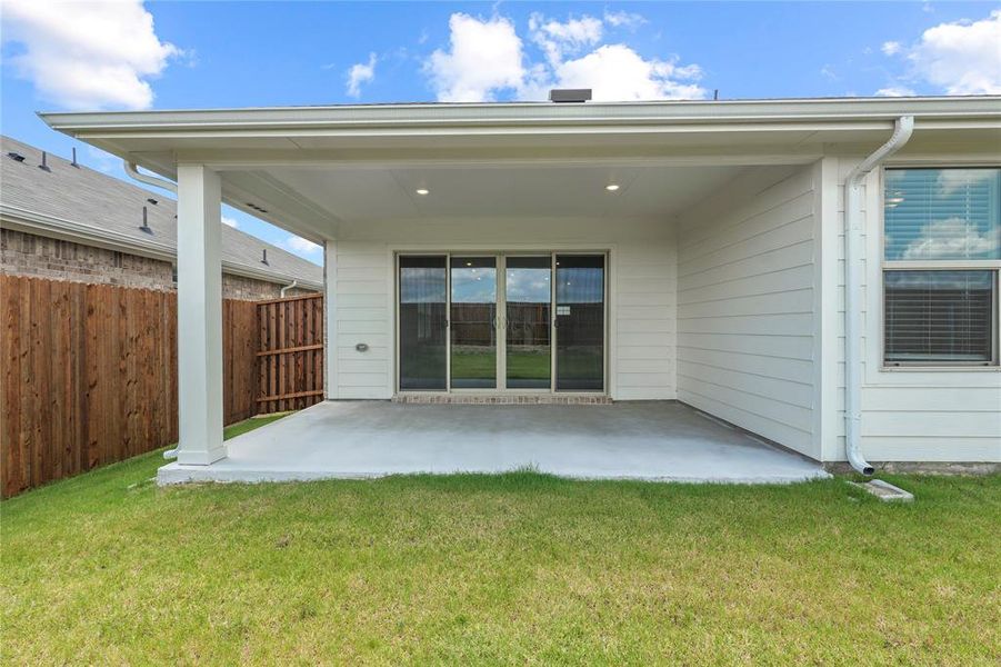 Rear view of property with a patio area Rear view of property with a patio area