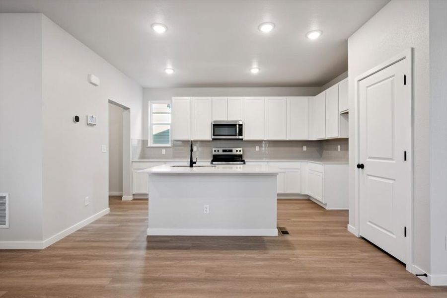 A kitchen with white cabinets. A kitchen with white cabinets.