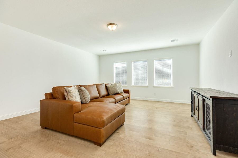 Gameroom/second family room featuring oversized windows, offering versatile space for endless possibilities.