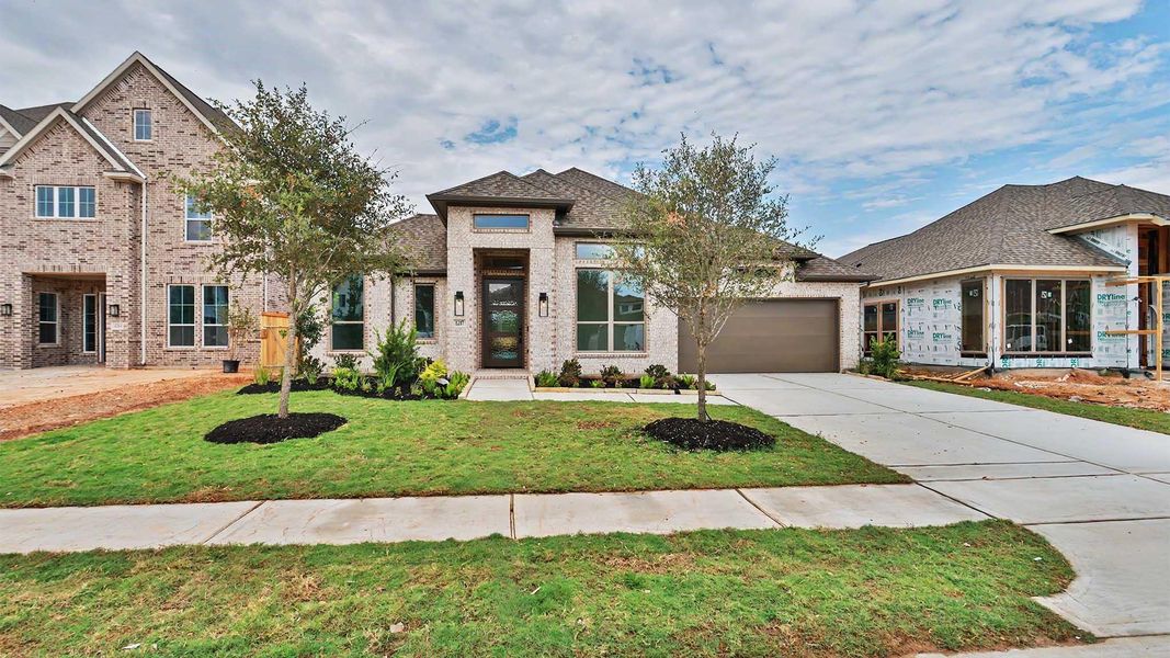 Front exterior of a new home in Lakes of Cane Island, Katy, TX, highlighting curb appeal (Image 2).