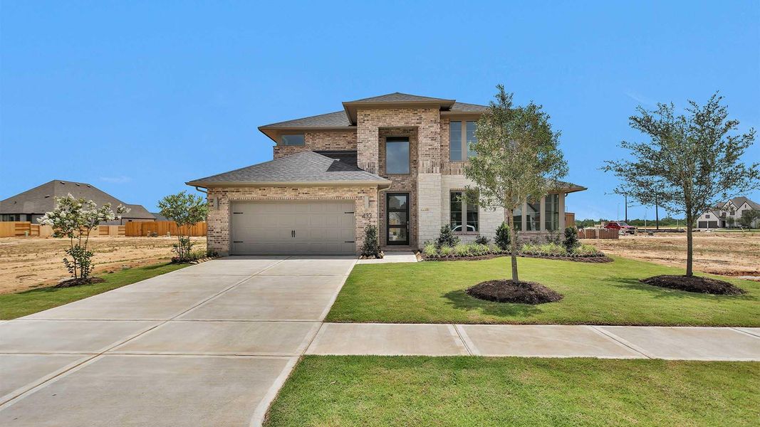 Front exterior of a new home in Grange 60', Katy, TX, highlighting curb appeal (Image 1).