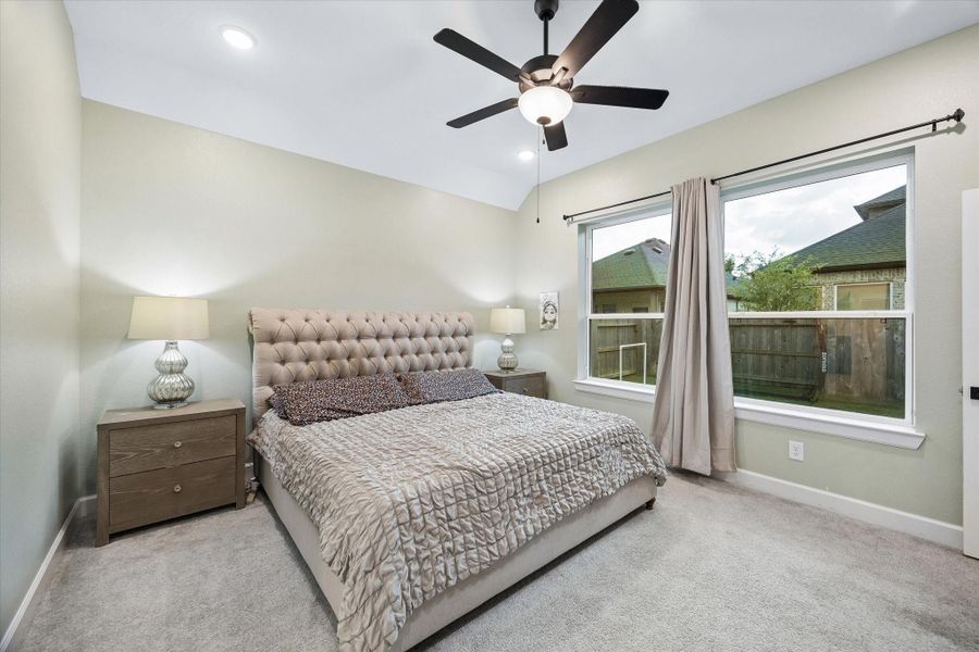 The luxurious primary suite serves as a peaceful retreat with soaring ceilings, oversized windows, soft natural light, and ample room for a private sitting area. The luxurious primary suite serves as a peaceful retreat with soaring ceilings, oversized windows, soft natural light, and ample room for a private sitting area.