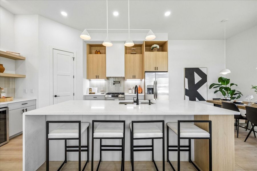 Custom Vicenza Oak cabinetry, quartz countertops with warm veining, and matte black fixtures bring timeless Scandinavian design to the heart of the home.
