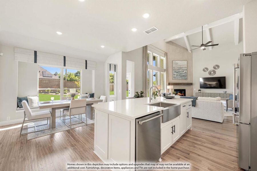 Open-concept kitchen with white island, farmhouse sink, and views into dining and living areas with vaulted ceiling