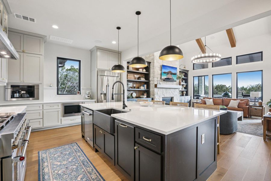 The gourmet kitchen is a true showstopper, dazzling with sleek quartz surfaces and modern design.