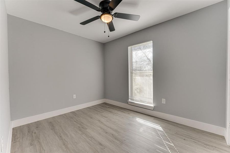 Spare room with ceiling fan and light hardwood / wood-style flooring