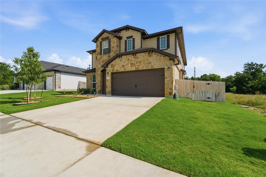 A striking facade with varied textures presents an inviting curb appeal. A striking facade with varied textures presents an inviting curb appeal.