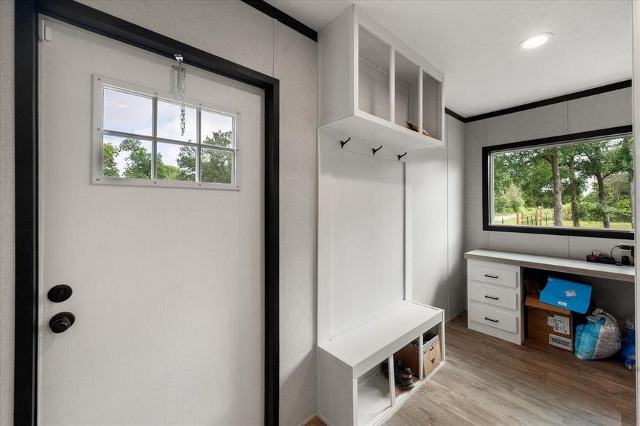 Rear entry featuring a built-in storage bench, open to the desk area. Rear entry featuring a built-in storage bench, open to the desk area.