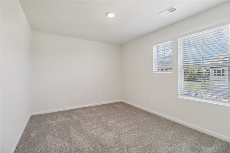 This bright and airy room features soft carpeting This bright and airy room features soft carpeting