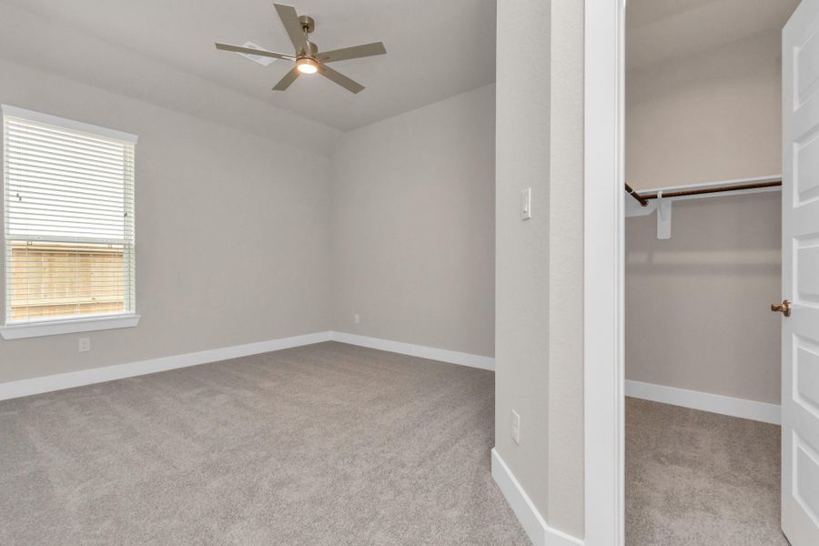 Elegance meets functionality in the generously sized secondary bedrooms, showcasing 5-panel doors with modern hardware, large windows adorned with privacy blinds, and spacious closets boasting sleek and contemporary finishes. Sample photo of completed home with similar floor plan. Actual colors and selections may vary. Elegance meets functionality in the generously sized secondary bedrooms, showcasing 5-panel doors with modern hardware, large windows adorned with privacy blinds, and spacious closets boasting sleek and contemporary finishes. Sample photo of completed home with similar floor plan. Actual colors and selections may vary.