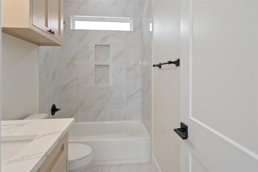 Bathroom featuring bathtub / shower combination and vanity Bathroom featuring bathtub / shower combination and vanity