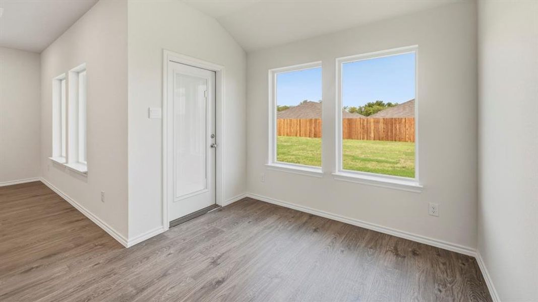 Foyer featuring plenty of natural light, light wood-type flooring, and lofted ceiling