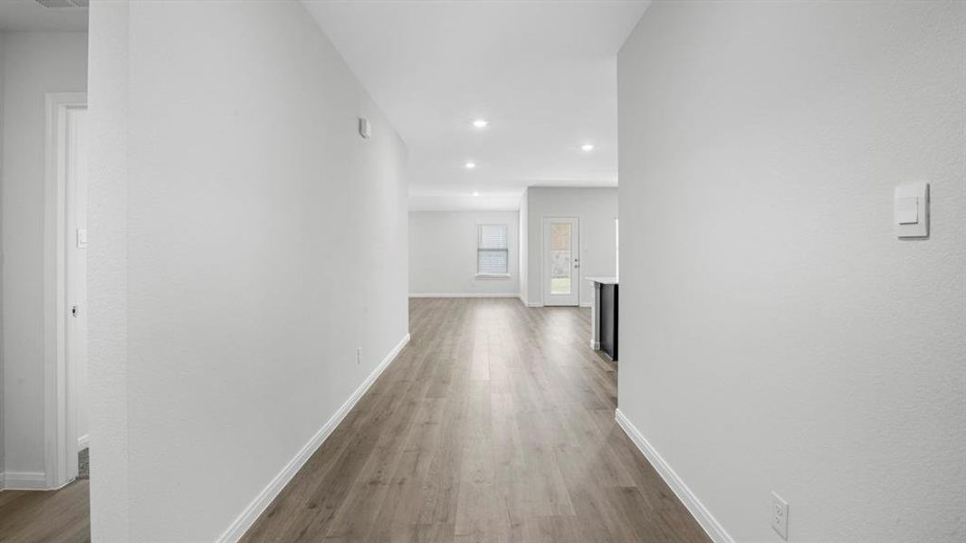 Hallway featuring light wood-style floors and recessed lighting