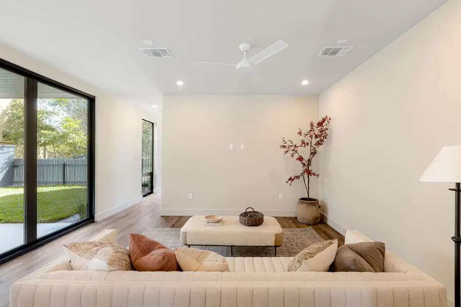 Living area with wood finished floors, recessed lighting, and a ceiling fan Living area with wood finished floors, recessed lighting, and a ceiling fan