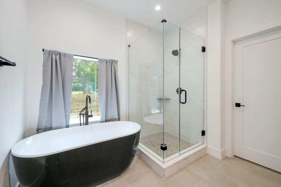 Full bath featuring a stall shower, a soaking tub, tile patterned flooring, and recessed lighting