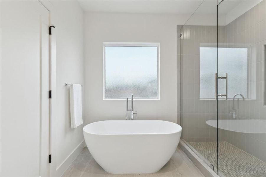 Bathroom featuring shower with separate bathtub