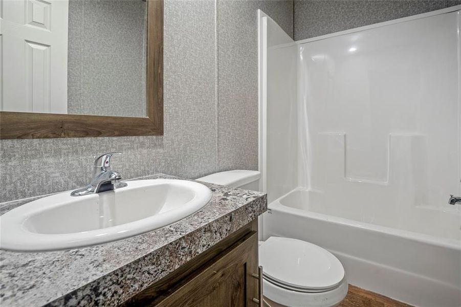 Full bath with vanity and shower / bath combination