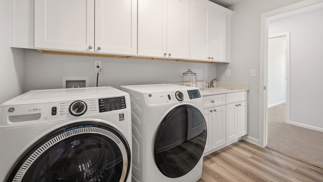 Dedicated laundry room with cabinetry and sink Dedicated laundry room with cabinetry and sink