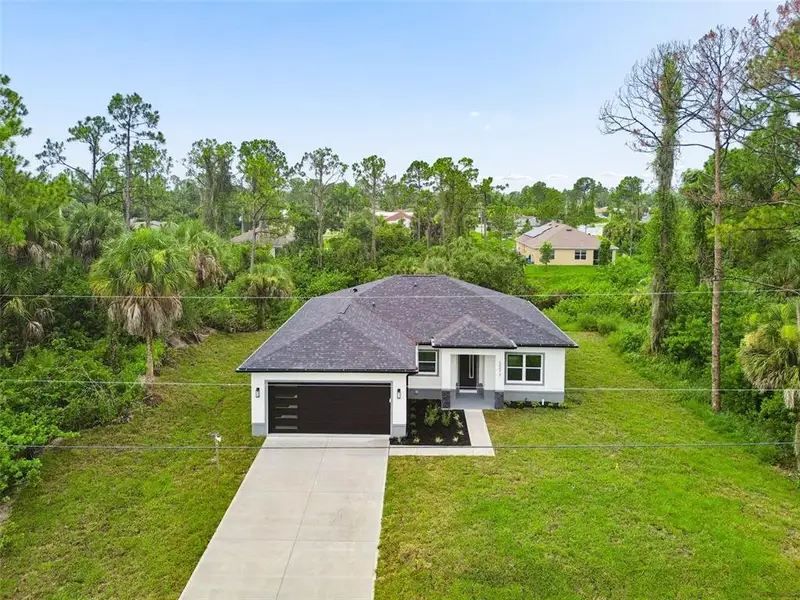 Front exterior of a new home in , North Port, FL, highlighting curb appeal (Image 2). Front exterior of a new home in , North Port, FL, highlighting curb appeal (Image 2).