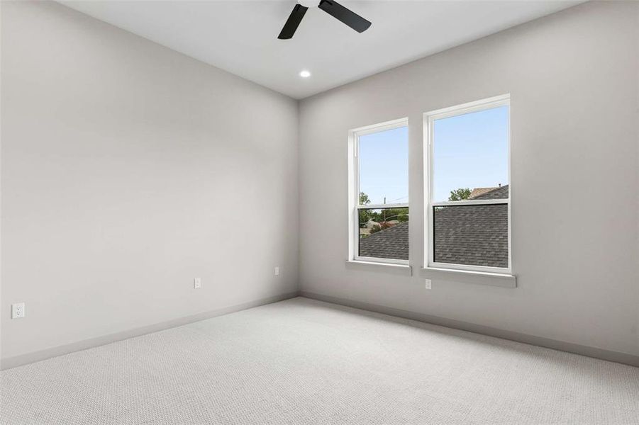 Second level bedroom with carpet, neutral paint, and ample natural light. Second level bedroom with carpet, neutral paint, and ample natural light.