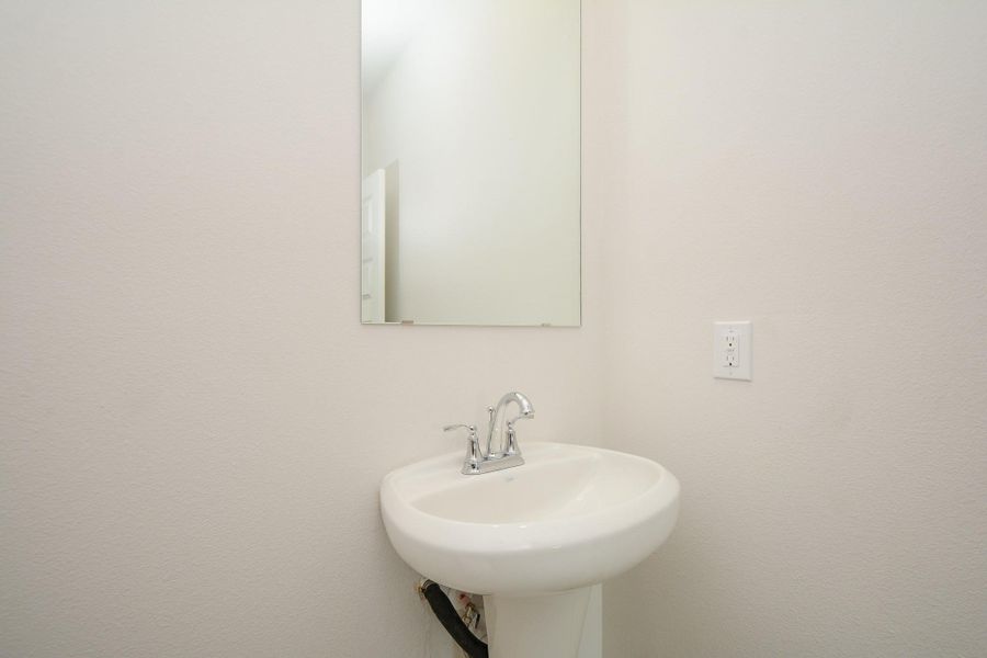 Welcome to this well-appointed half bathroom.