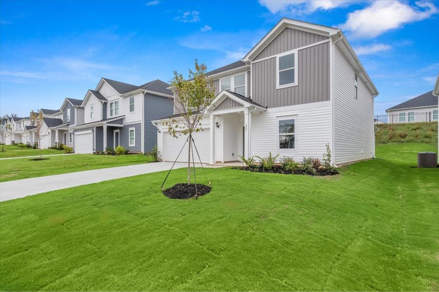 Front exterior of a new home in The Farm at Wells Creek - Signature Collection, Gray Court, SC, highlighting curb appeal (Image 2). Front exterior of a new home in The Farm at Wells Creek - Signature Collection, Gray Court, SC, highlighting curb appeal (Image 2).