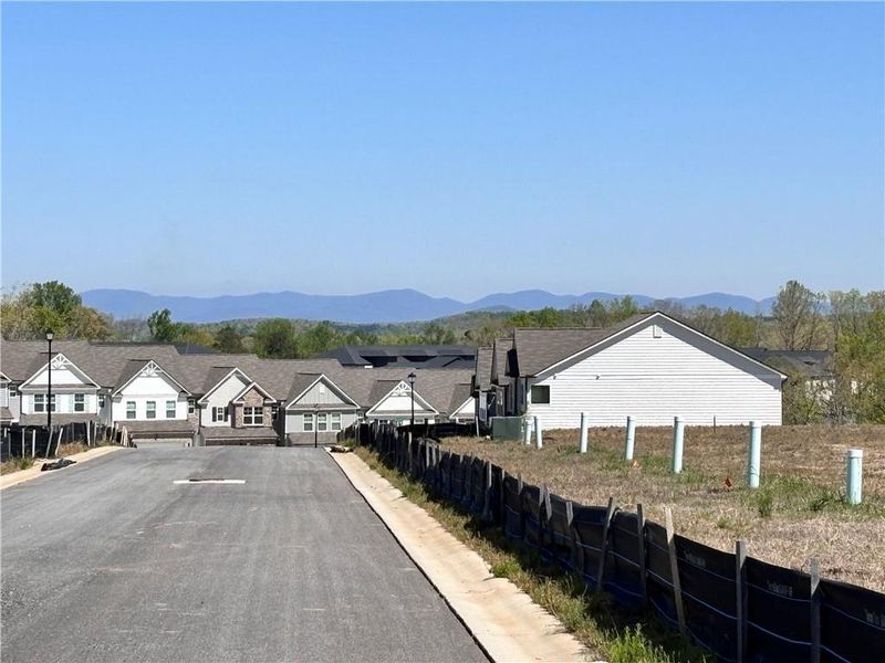 Front exterior of a new home in Somerset at Riverbrook, Gainesville, GA, highlighting curb appeal (Image 2). Front exterior of a new home in Somerset at Riverbrook, Gainesville, GA, highlighting curb appeal (Image 2).