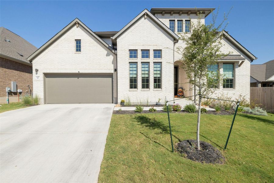 View of front of home with concrete driveway, brick siding and 2-car garage on the Zavala floorplan View of front of home with concrete driveway, brick siding and 2-car garage on the Zavala floorplan