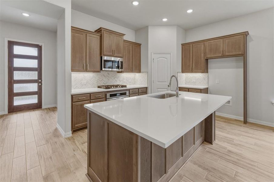 Central kitchen island with a white countertop and integrated sink