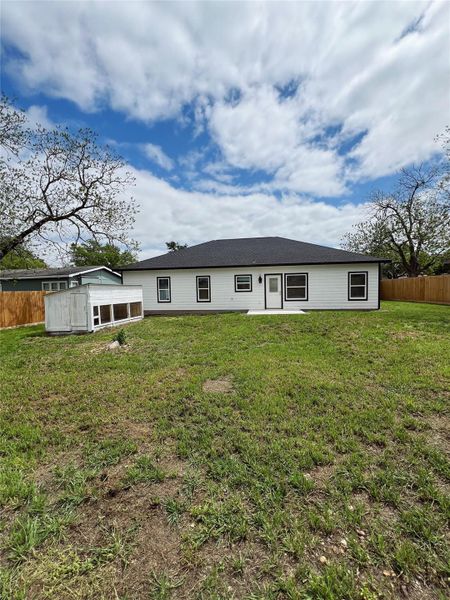 Back of property with a yard and fence Back of property with a yard and fence