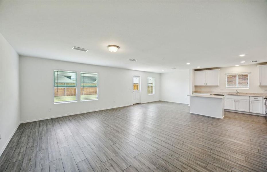 Bright gathering room with large windows *real home pictured