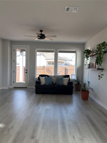 Spacious room featuring light wood-finish flooring