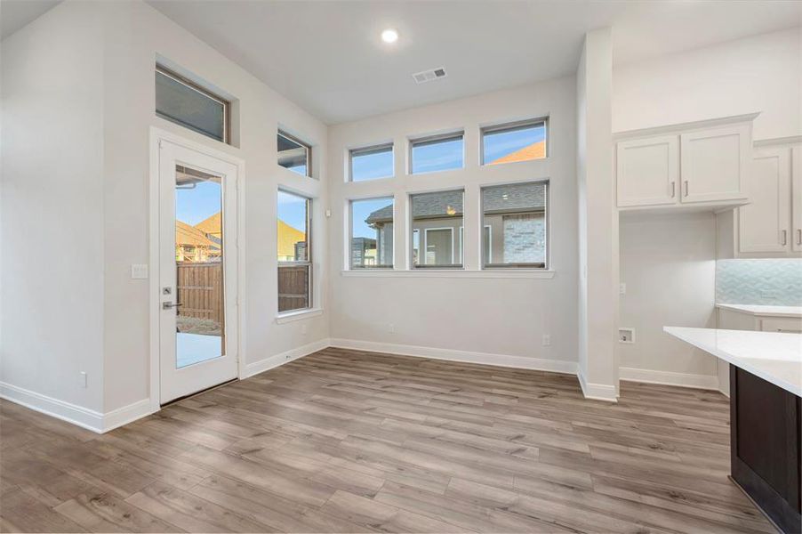 Unfurnished dining area featuring light wood-type flooring and recessed lighting