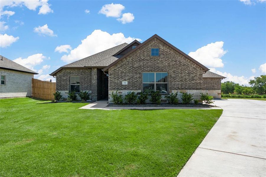 Front exterior of a new home in High Meadows Estates, Nevada, TX, highlighting curb appeal (Image 2).