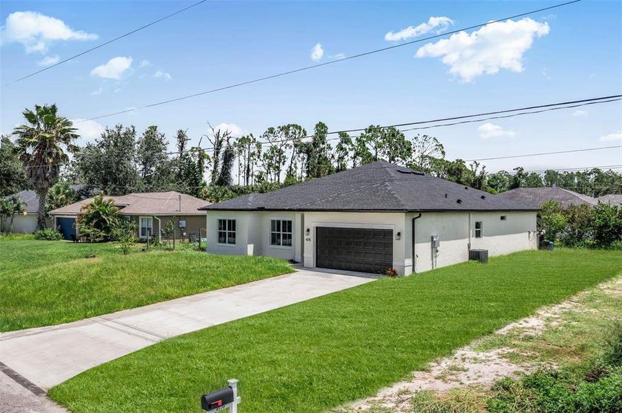 Front exterior of a new home in , North Port, FL, highlighting curb appeal (Image 26). Front exterior of a new home in , North Port, FL, highlighting curb appeal (Image 26).